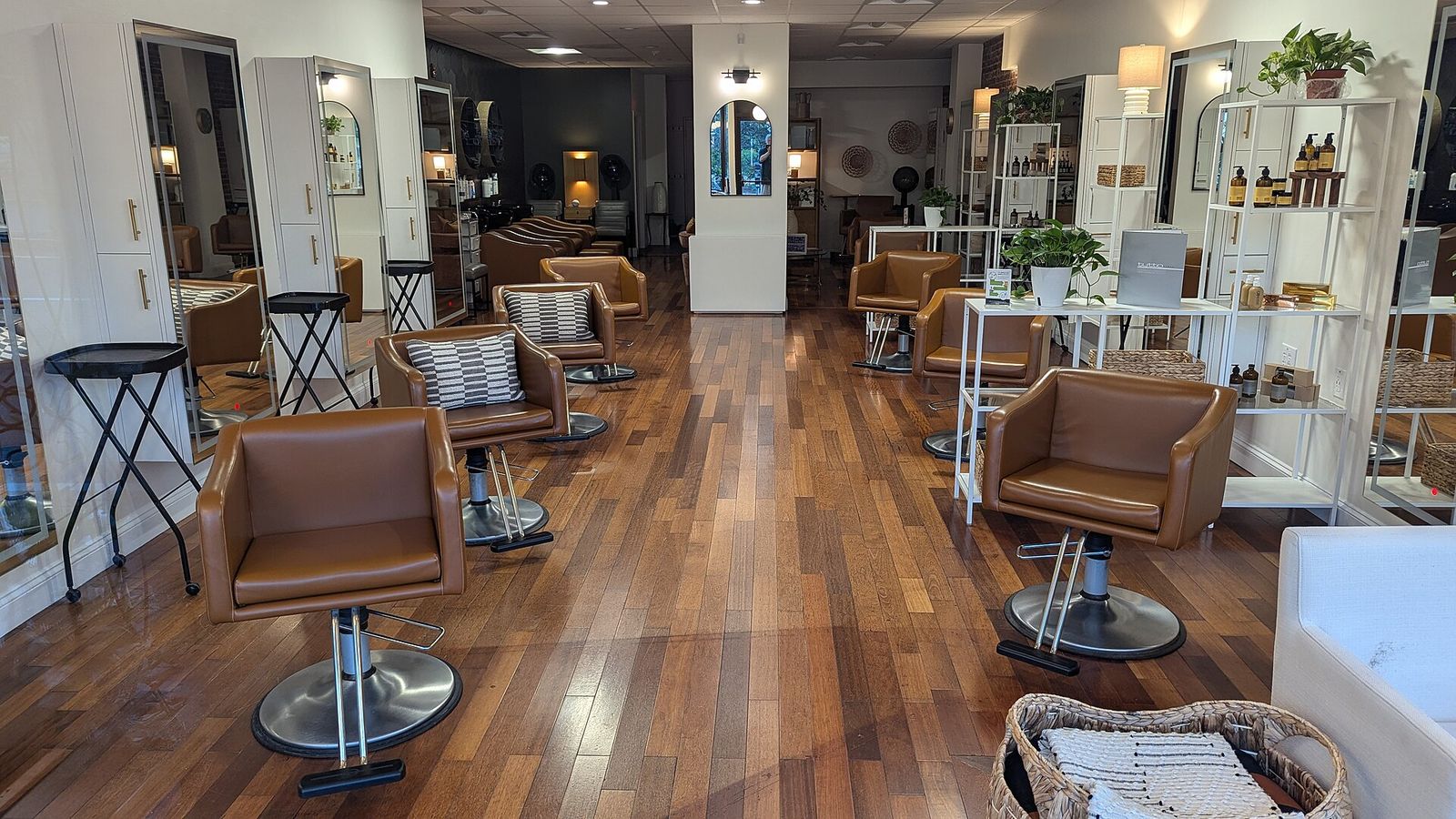 The salon: styling chairs in a row along a wooden floor.
