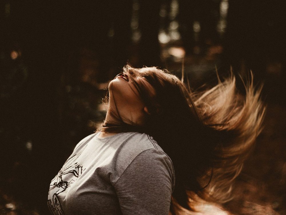 Hair caught mid-flip in warm light