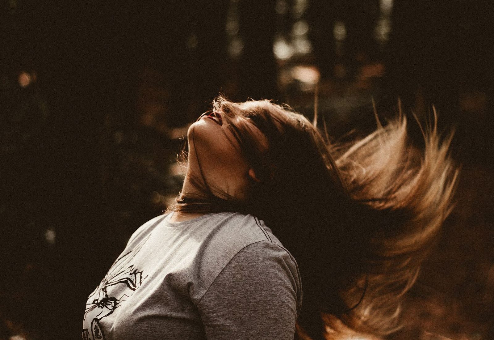 Hair caught mid-flip in warm light